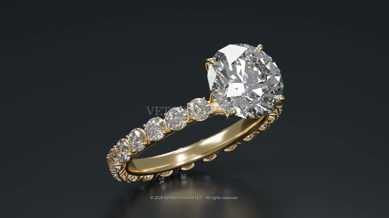 A gold diamond ring lit against a dark background
